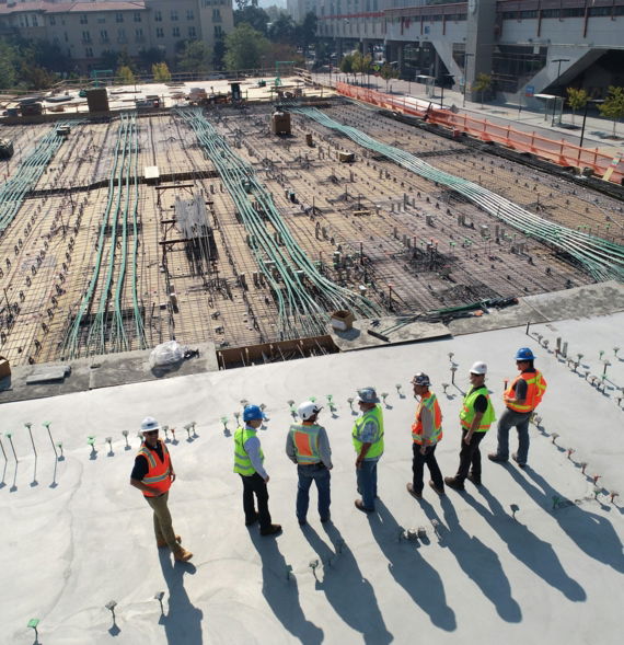 seven-construction-workers-standing-on-white-field.jpg seven construction workers standing on white field